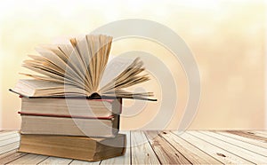 Old stacked books on light background