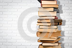 Old stacked books on table background
