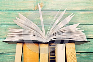 Old stacked books on table background