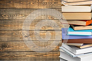 Old stacked books on wooden background