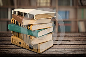 Old stacked books on wooden background