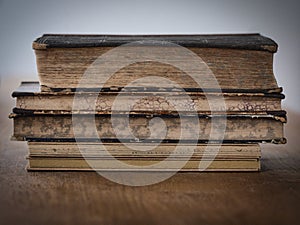 Old stacked books on a wooden table