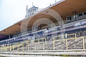 Old stadium for a large number of spectators. Abandoned grandstands and buildings