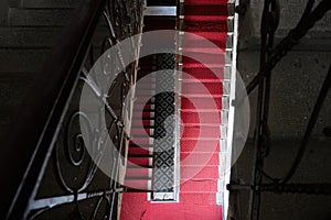 Old stairs in the historical palace. Classic stairways with red carpet.