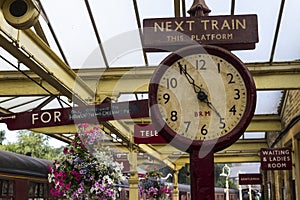 Old station clock on platform of Keighley Station, Worth Valley Railway. Yorkshire, England, UK,