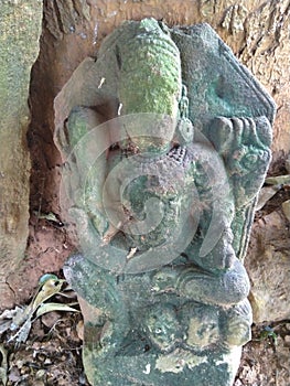 Old statue of asian goddes looks devotional