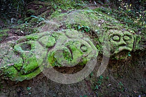 Old statue in Goa Gajah elephant cave, Ubud, Bali, Indonesia photo