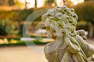 Stone angel statue in garden. Guardian angel statue in sunlight as a symbol of love in garden.