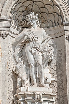 Old statue of a sensual Baroque Era man in downtown of Dresden, Germany, details, closeup