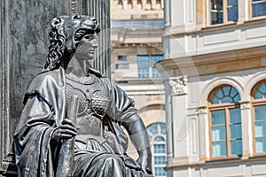 Old statue of a sensual woman warrior, Amazonian, as defender with lion head and club at the Neumarkt in downtown of Dresden,