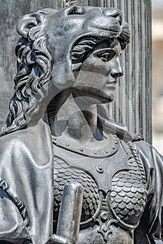 Old statue of a sensual woman warrior, Amazonian, as defender with lion head and club at the Neumarkt in downtown of Dresden,