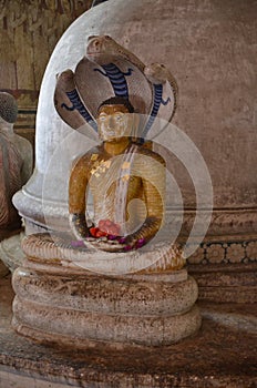 Old statue of a sitting Buddha in the ancient Buddhist cave temple in Dambulla, Sri Lanka