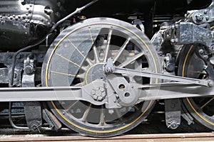 Old steam engine train wheel and rods.