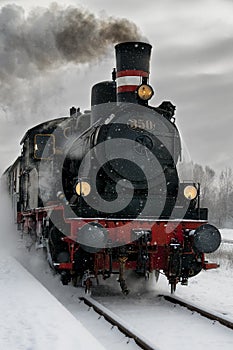 Old steam locomotive in the snow photo