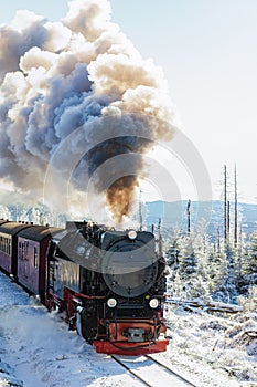 An old steam locomotive in snow-covered landscape