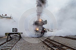 Old steam train, lots of black and gray steam