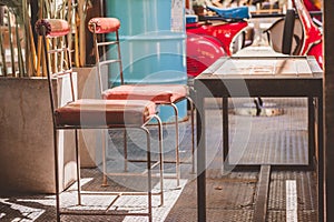 Old steel chair and steel table with sunlight in coffee shop