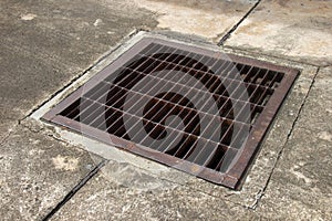 Old steel grate for drainage on concrete floor.