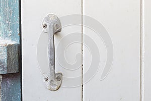 Old steel handle on wooden door with copyspace.