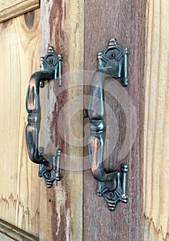 Old steel handles on wooden cupboard