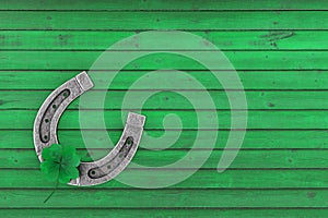 Old Steel Lucky Horseshoe with  Green Clover Four Leaf . 3d Rendering