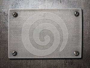 Old steel plate with bolts on metal background