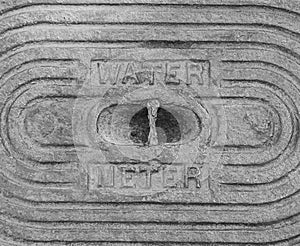 An old steel water meter cover dug out of the ground photo