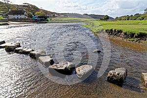 Old stepping stones to cross Ewenny River at Ogmore Castle