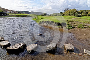 Old stepping stones to cross Ewenny River at Ogmore Castle