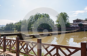 Old stone beam bridge over river in sunny autumn