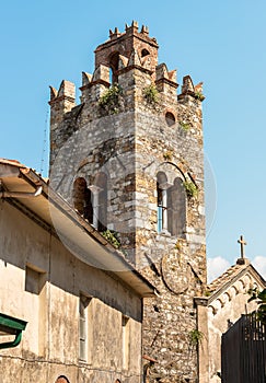 Old stone bell tower in the Tuscany village Mommio Castello, Italy photo