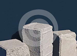 Old stone blocks in row against dark blue background. 3d computer graphic template of displaying place for your products