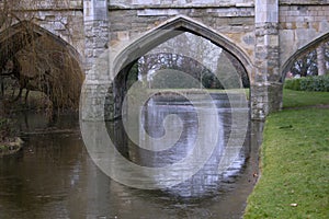 Old stone bridge arches with moat in England