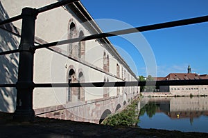 old stone bridge (barrage vauban), commandery saint-jean and ill river - strasbour - france