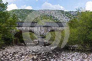 Old stone bridge and dry riverbed