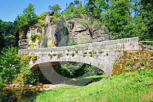 Old stone bridge over a small rivulet