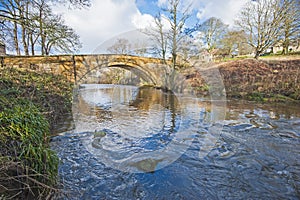 Old stone bridge over a stream