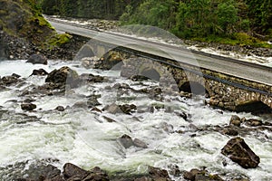 Old stone bridge. Road crossing river. Latefoss, Norway