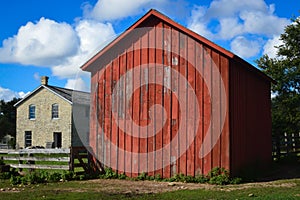 Old Stone Building with A Red Barn Building