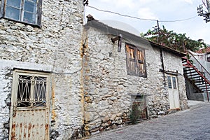 Old, stone buildings in the countryside.