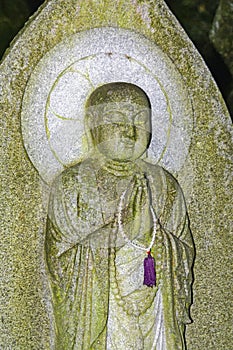 Old stone-carved praying Jizo Budhist statues