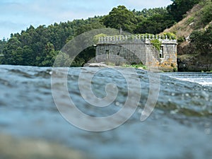 Old stone castle ruin on the river Ave in Vila do Conde, Portugal.