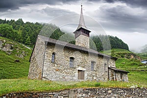 Old stone church in Andermatt, Switzerland.