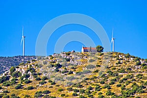 Old stone church and green energy plant