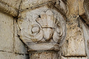 old stone column head closeup. fine details and texture. artistic carving. ornamental pattern
