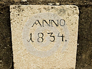 Old stone with engraved year.