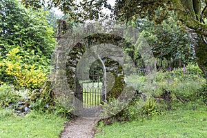 Old stone entrance gate in the garden.