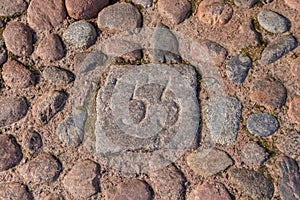 Old stone figures on the pavement in the masonry on the square figure 34 middle ages