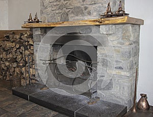 Old stone fire palce with copper ornaments photo