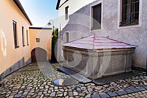 Old stone fountain on beautiful cobbled street, Tabor, Czech Republic